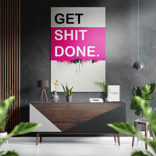Bold pink Get Shit Done poster on brushed aluminium dibond above geometric sideboard