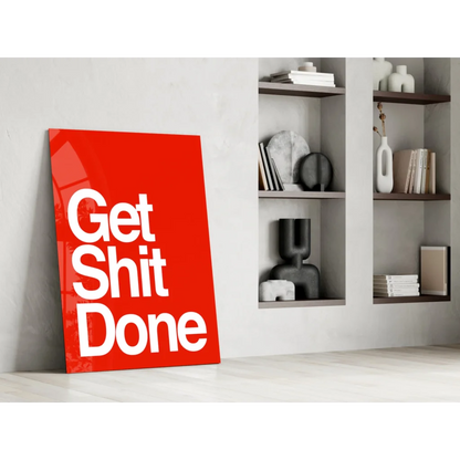 Vibrant red Get Shit Done glass wall art leaning against wall