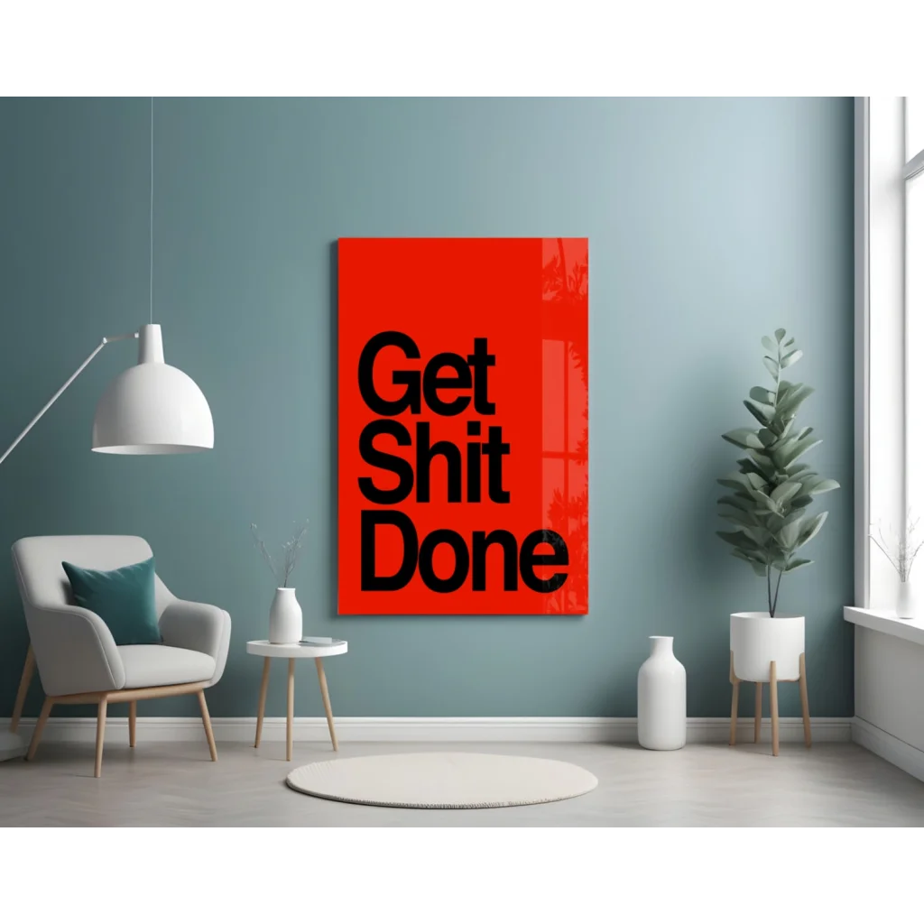 Vibrant red glass wall art with bold black Get Shit Done text on teal wall