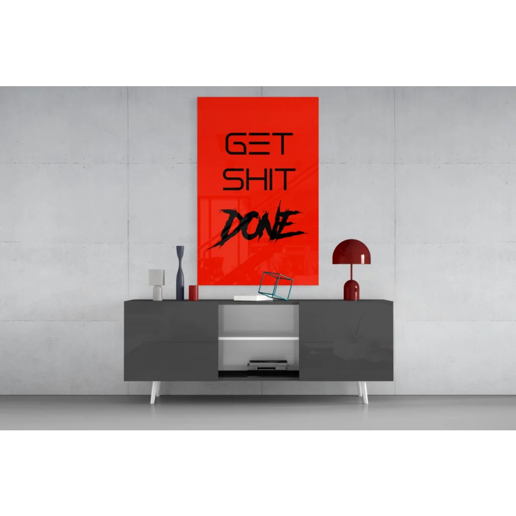 Vibrant red Get Shit Done glass wall art on gray console