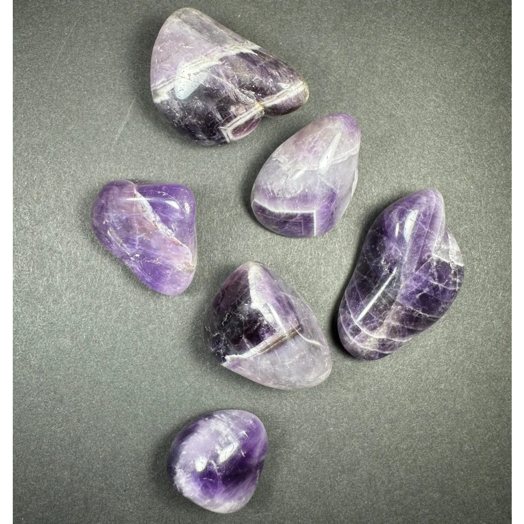 Giant large tumbled amethyst stones in purple shades with white veining