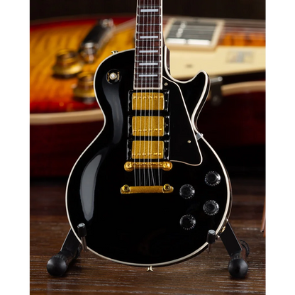 Black Gibson Les Paul mini guitar collectible with gold hardware