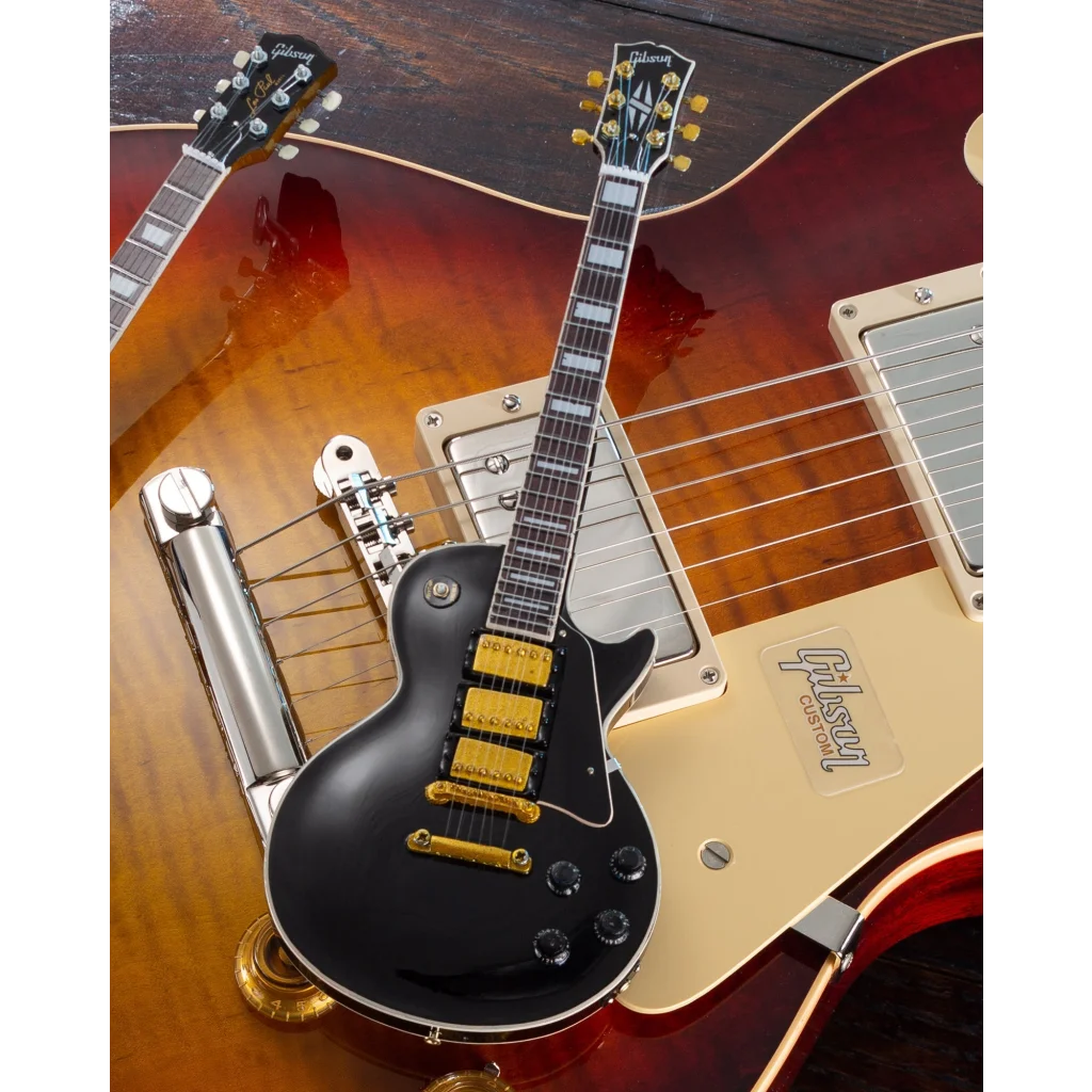 Black Gibson Les Paul mini guitar collectible with gold hardware