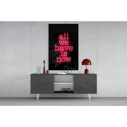 Glowing pink neon glass wall art sign reading all we have is now