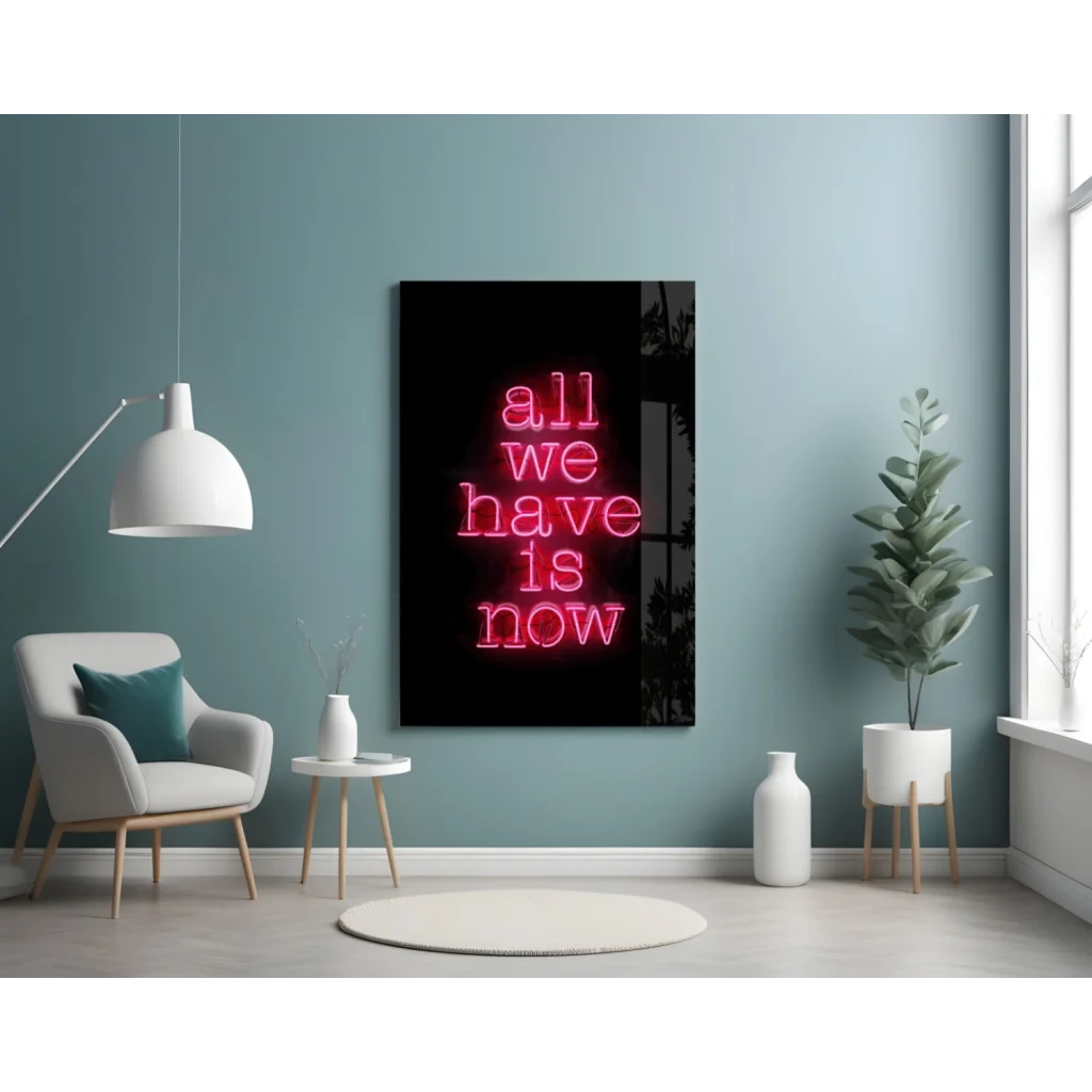 Glowing pink neon glass wall art sign: All we have is now on black background