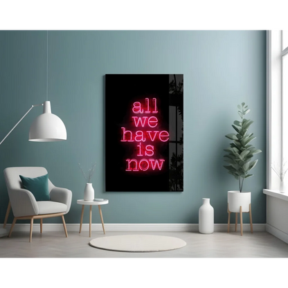 Glowing pink neon glass wall art sign: All we have is now on black background