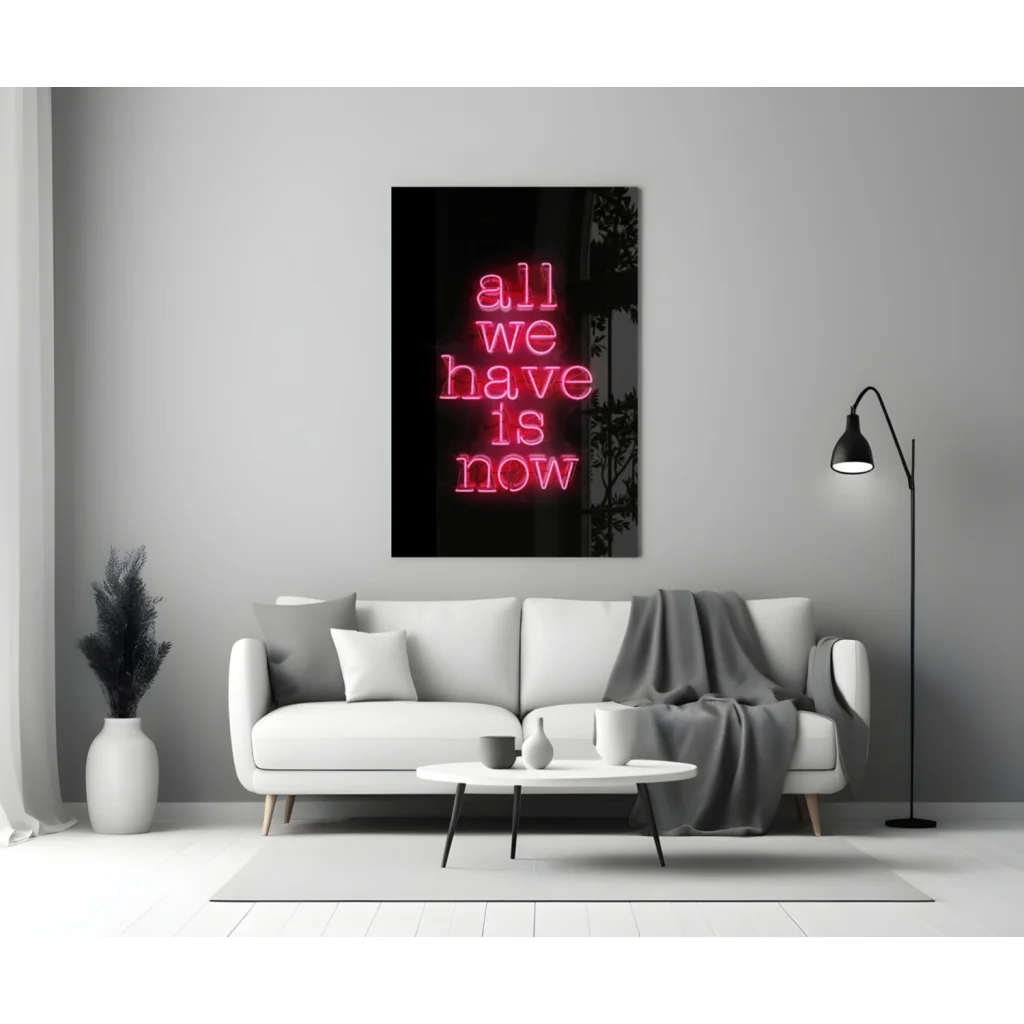 Vibrant pink neon glass wall art sign reading all we have is now in living room