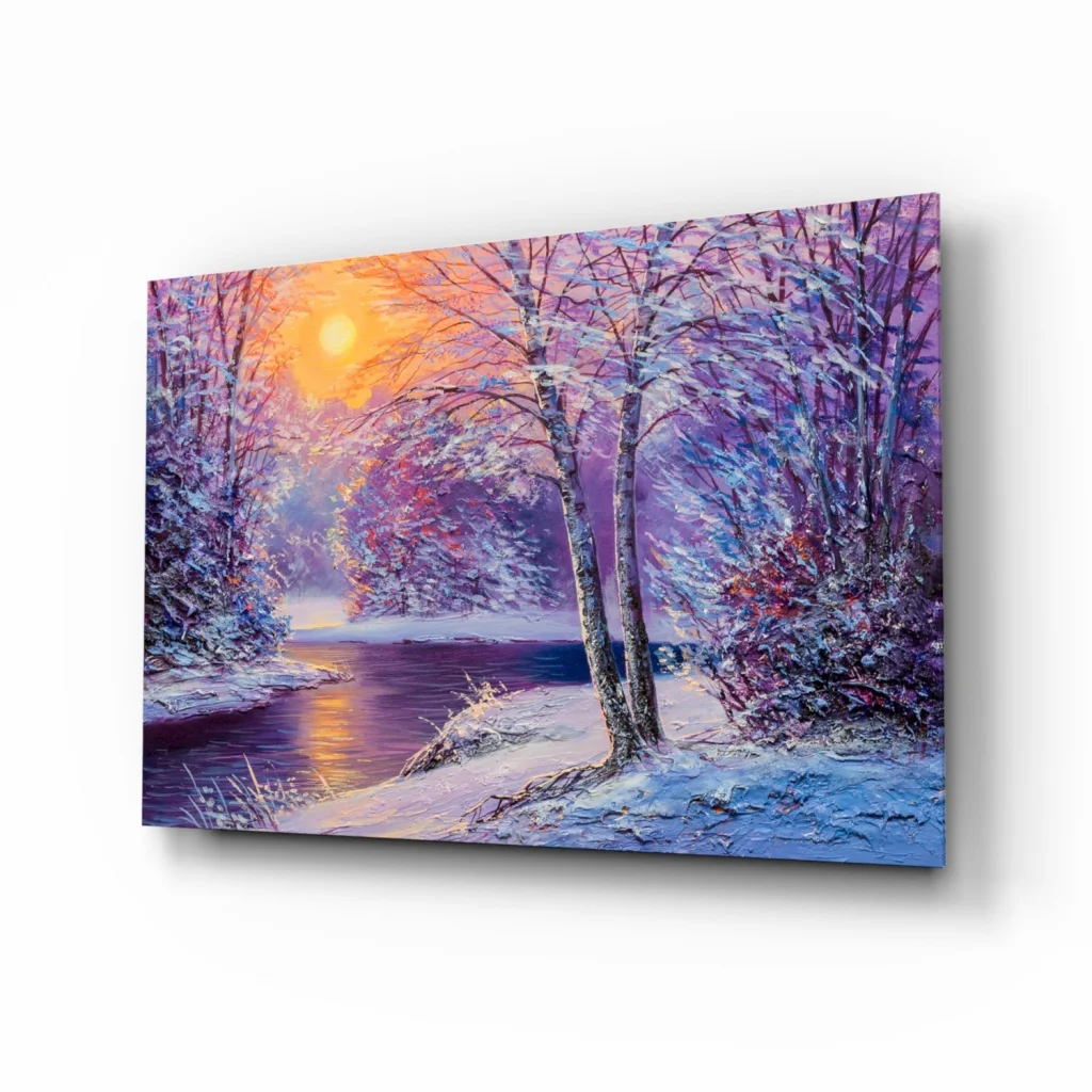 Vibrant winter sunset glass wall art with snow trees and glowing sun