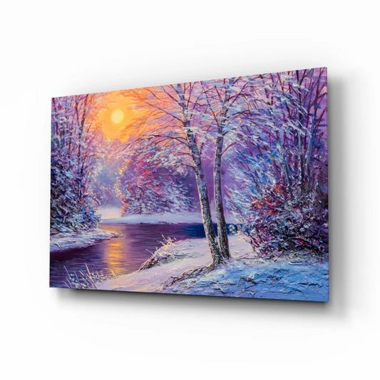 Vibrant winter sunset glass wall art with snow trees and glowing sun