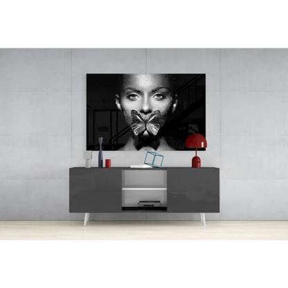 Black-and-white portrait of woman with metallic butterfly over mouth, glitter butterfly kiss glass wall art canvas
