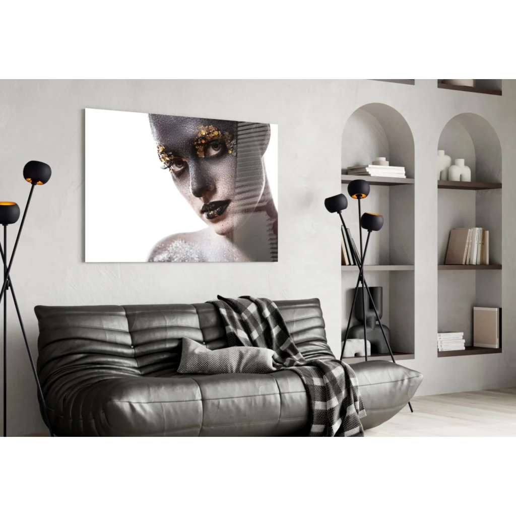 Black leather sofa with plaid throw on glittering gold portrait glass wall art