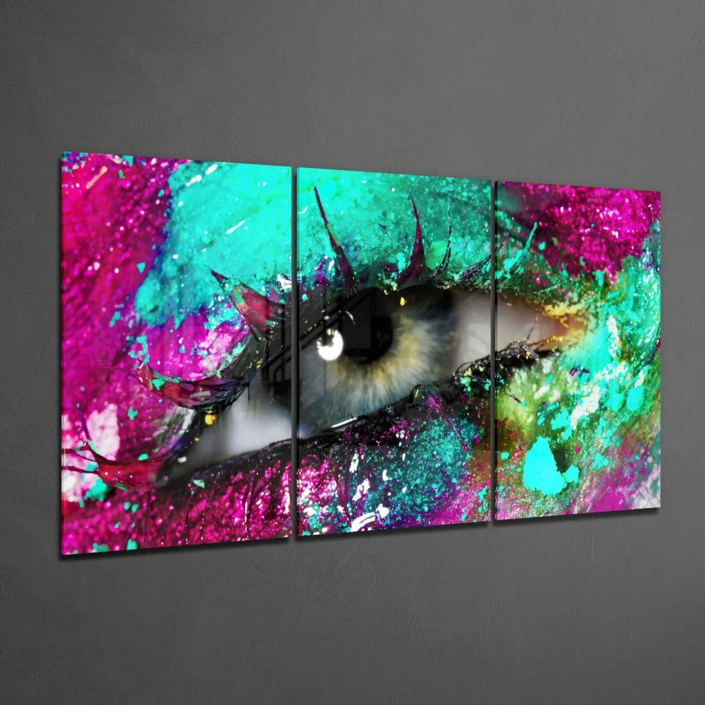 Vibrant tri-panel wall art of stylized glittery eye with pink teal splashes