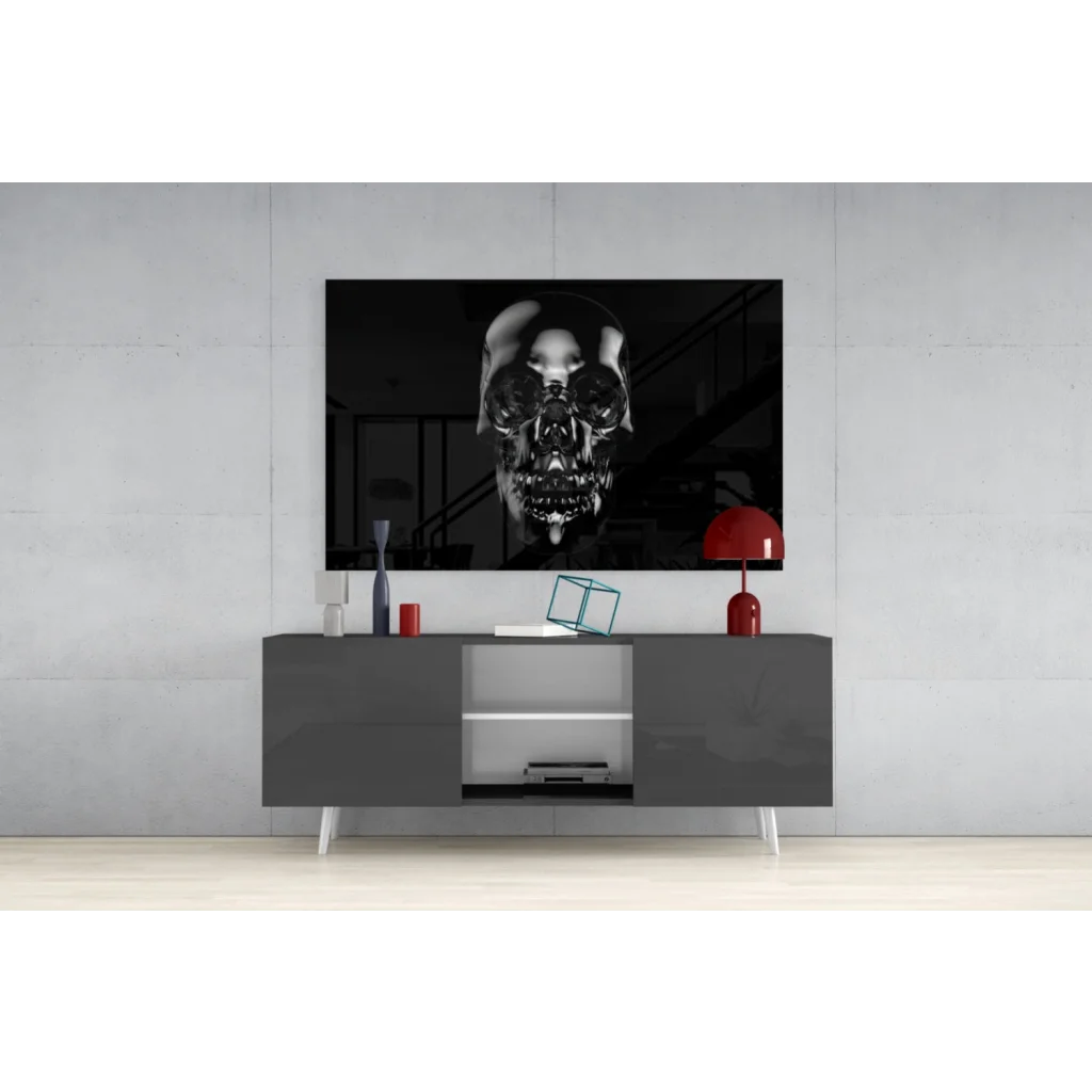 Glossy black skull wall art with metallic shine above gray console