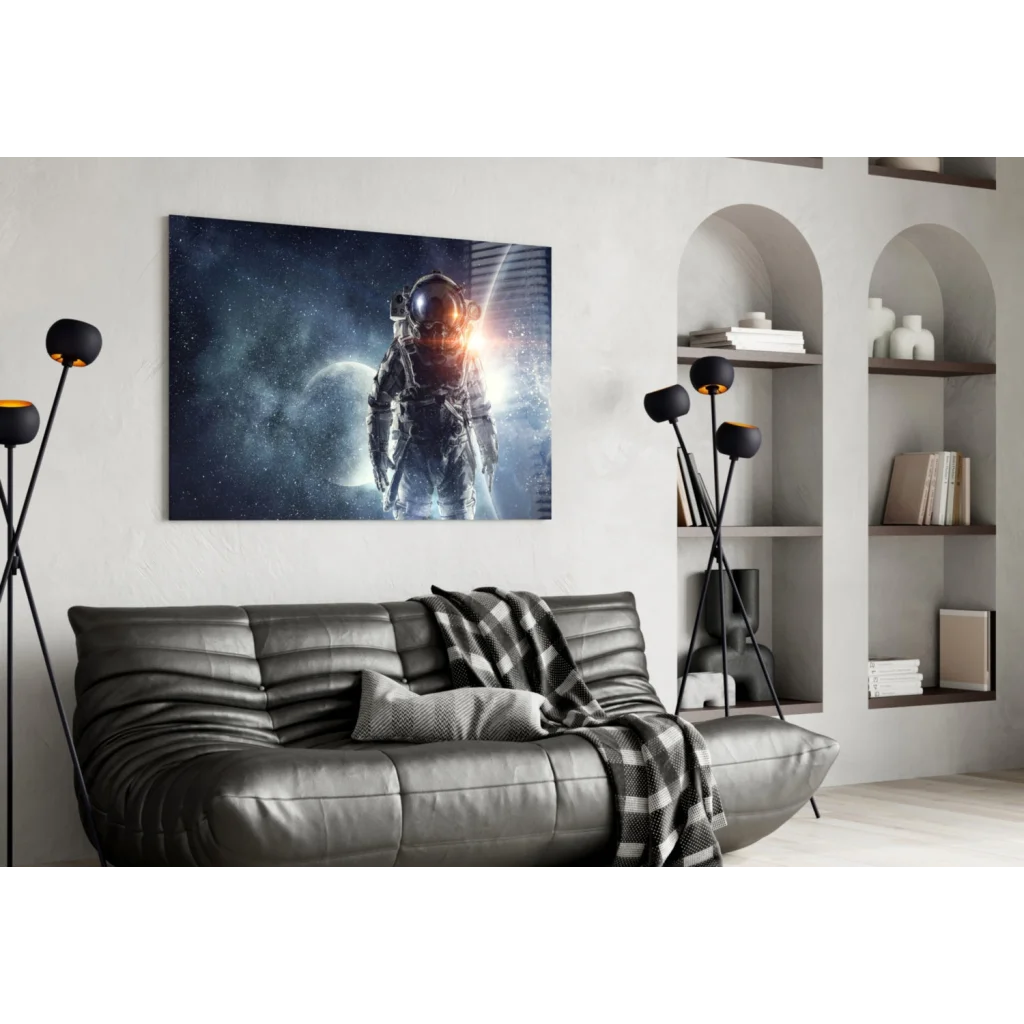 Black leather couch with textured pattern and checkered throw blanket under glowing astronaut space wall art