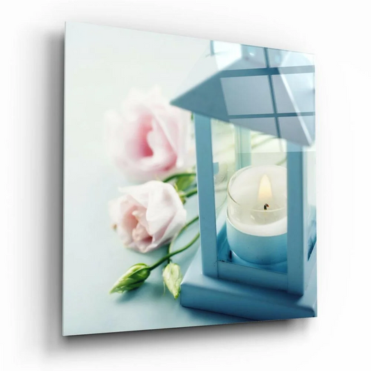 Glowing blue lantern glass wall art with lit candle and pink roses