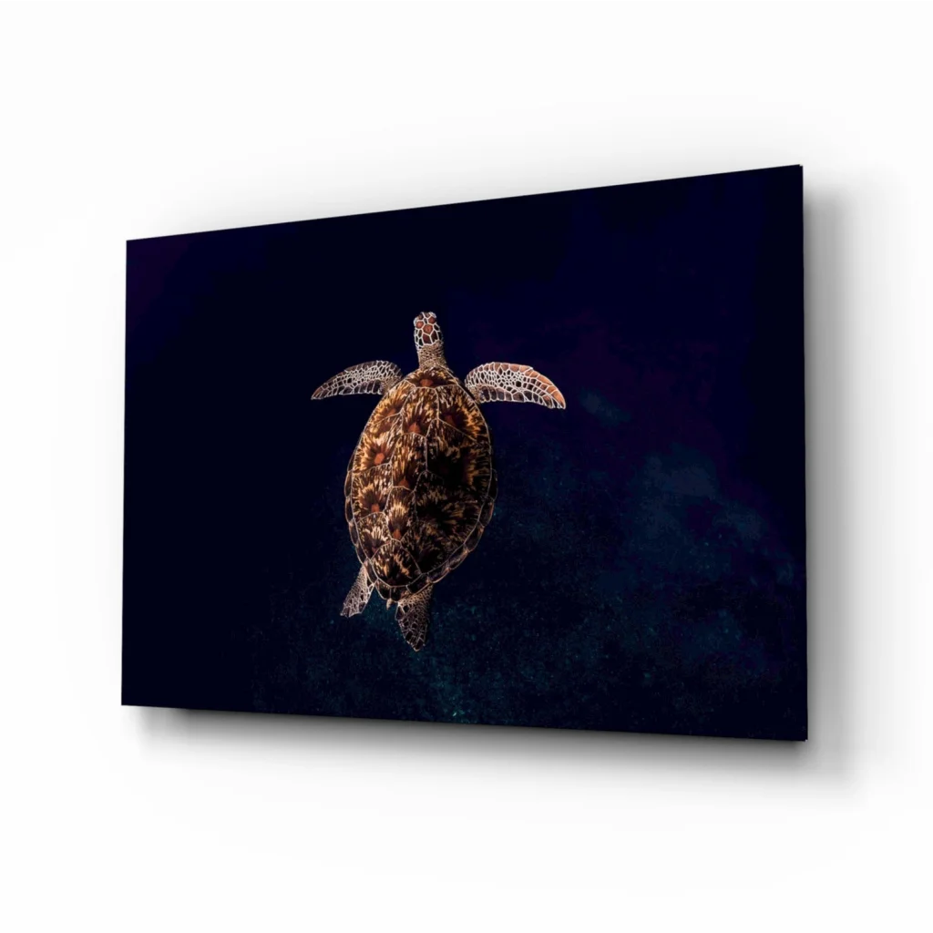 Glowing sea turtle glass wall art with textured shell on dark canvas