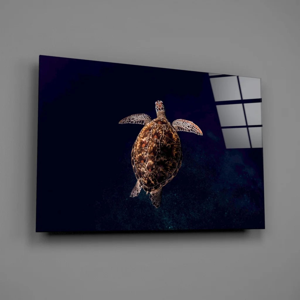 Glowing sea turtle glass wall art with textured shell on dark blue canvas