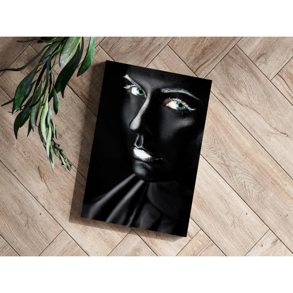 Black canvas portrait with glowing teal eyes and silver accents
