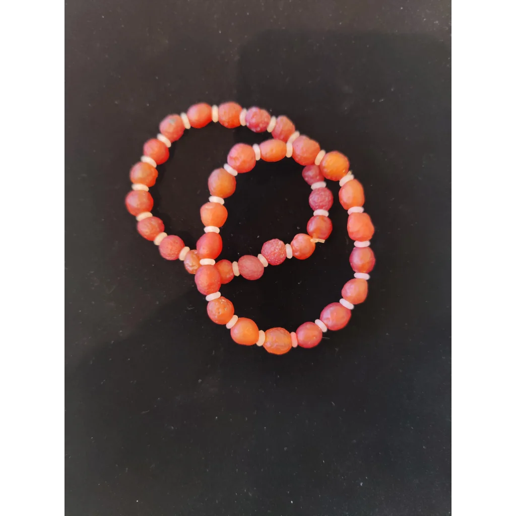 Two interlocking Gobi Desert agate bracelets with orange and pink beads
