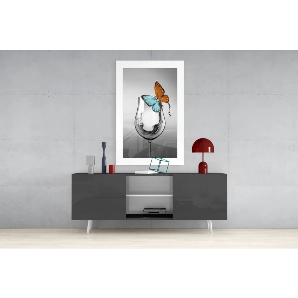 Framed black-and-white glass wall art of orange blue butterfly on wine glass