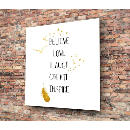 Gold feather tempered glass art with motivational text on white background