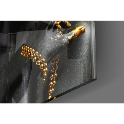 Golden beaded necklace on gloved hand in stunning glass wall art