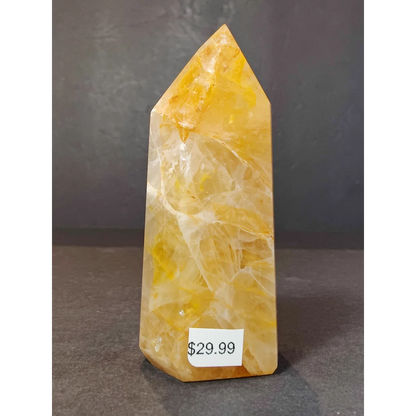 Golden healer obelisk tower sculpture made of translucent yellow and white citrine crystal with natural banding