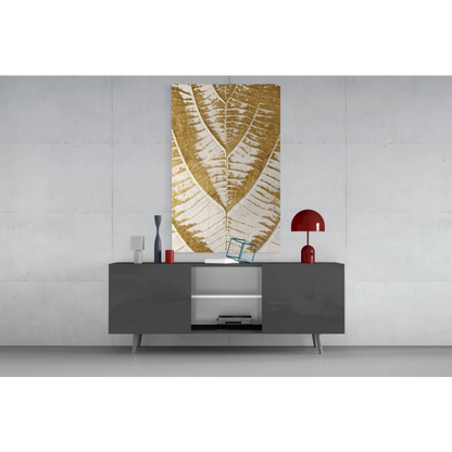 Modern golden leaf wall art canvas in gold and white on gray table