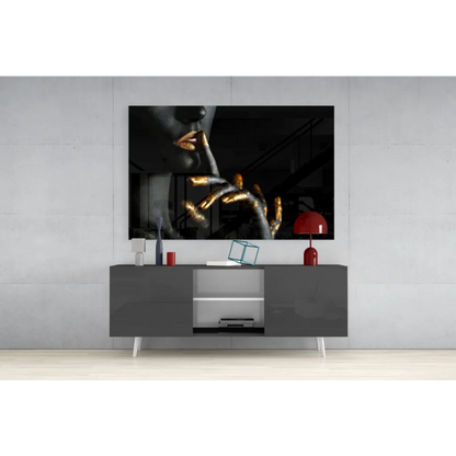 Black and gold abstract portrait wall art with golden hand near lips
