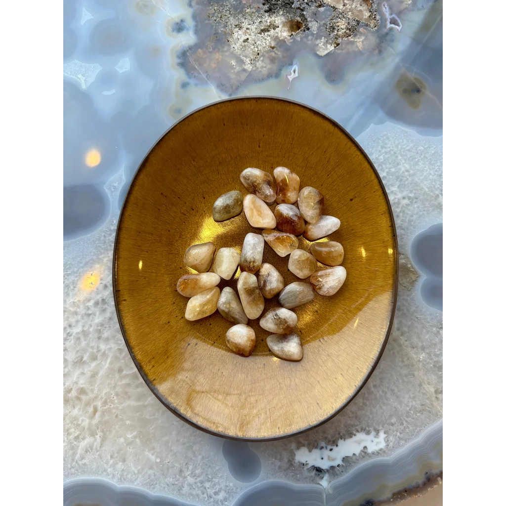 Gorgeous tumbled citrine stones in amber bowl energizing space
