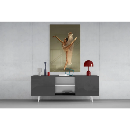 Beige canvas wall art of leaping ballerina in white tutu on gray console
