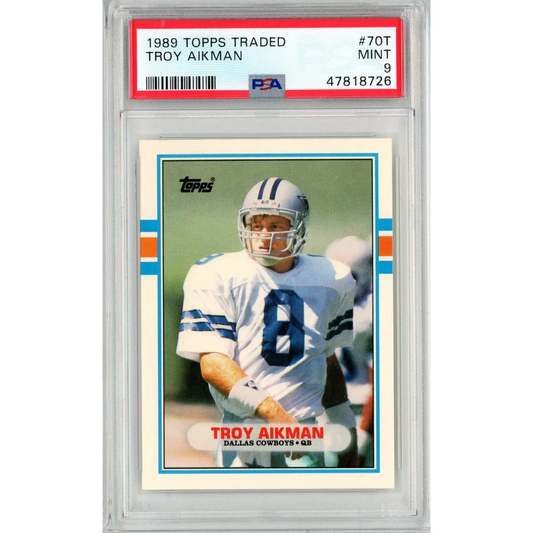 1989 Topps Traded Troy Aikman Rookie Card graded PSA Mint 9 on display