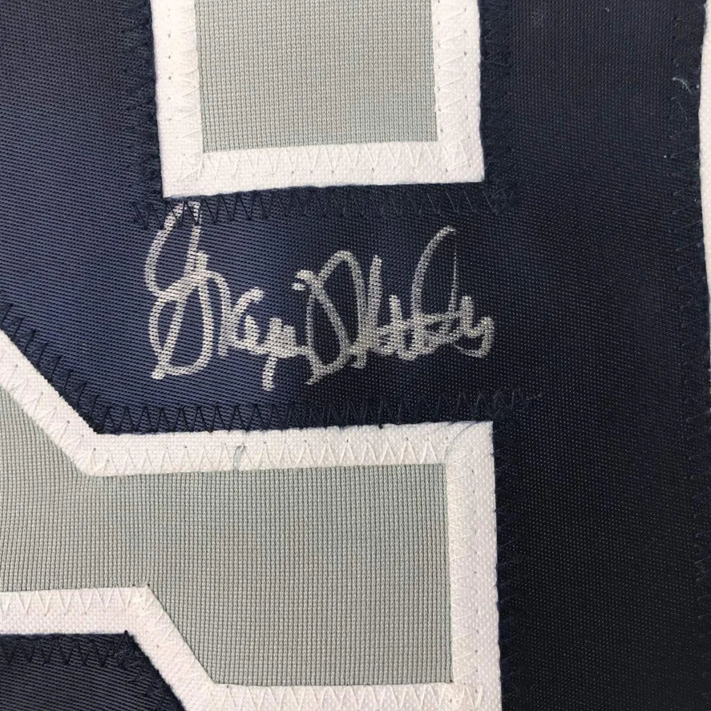 Autographed dark blue Yankees jersey with grey and white numbers in framed display