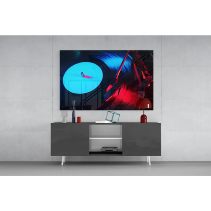 Sleek gray media console with white legs under Neon Vinyl Record glass wall art
