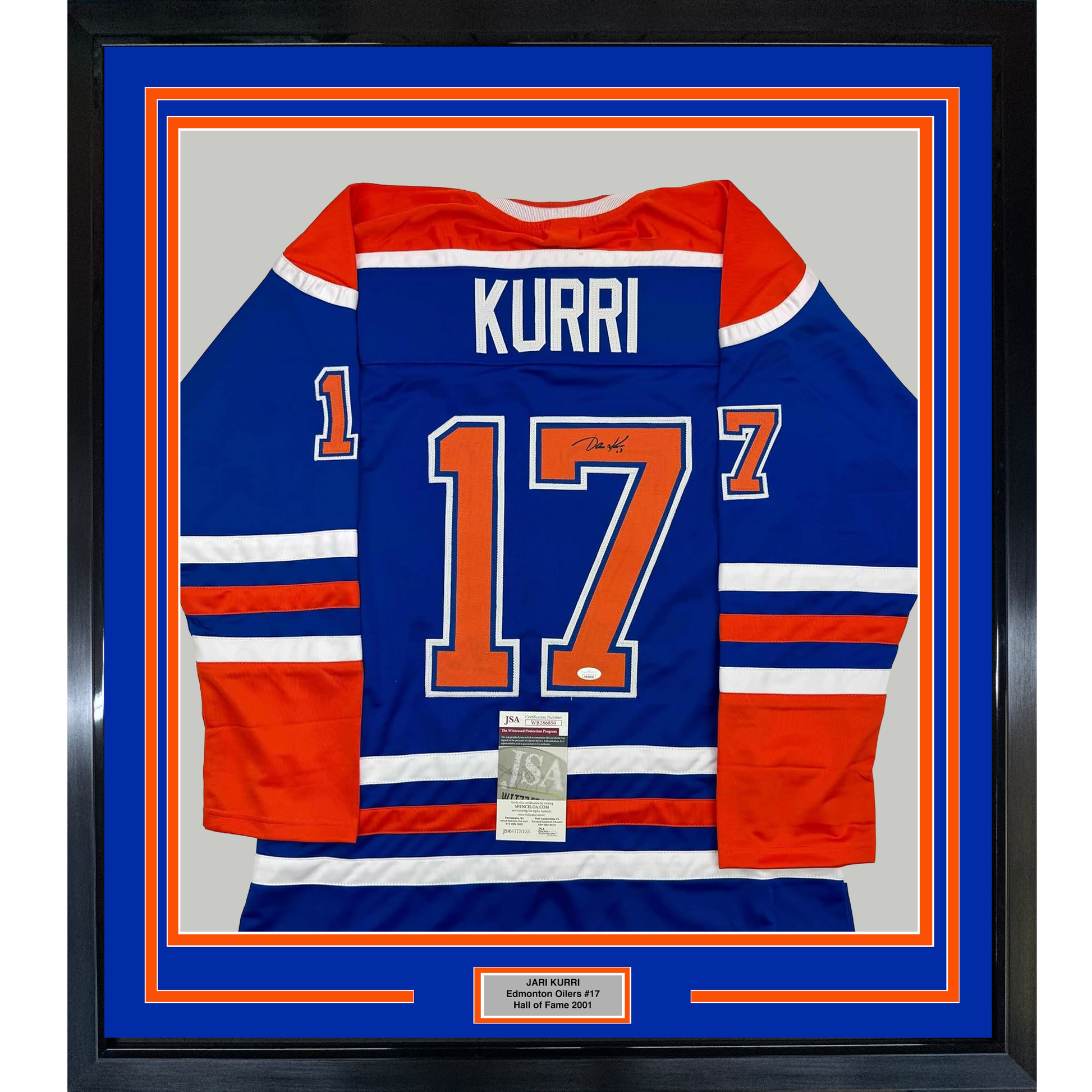Framed Edmonton Oilers #17 Kurri blue jersey with red and white stripes, displayed flat against gray background with authentication certificate visible.