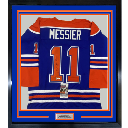 Framed Edmonton Oilers blue jersey number 11 with "MESSIER" nameplate, signed, displayed front-facing in blue and orange matting with authentication certificate.