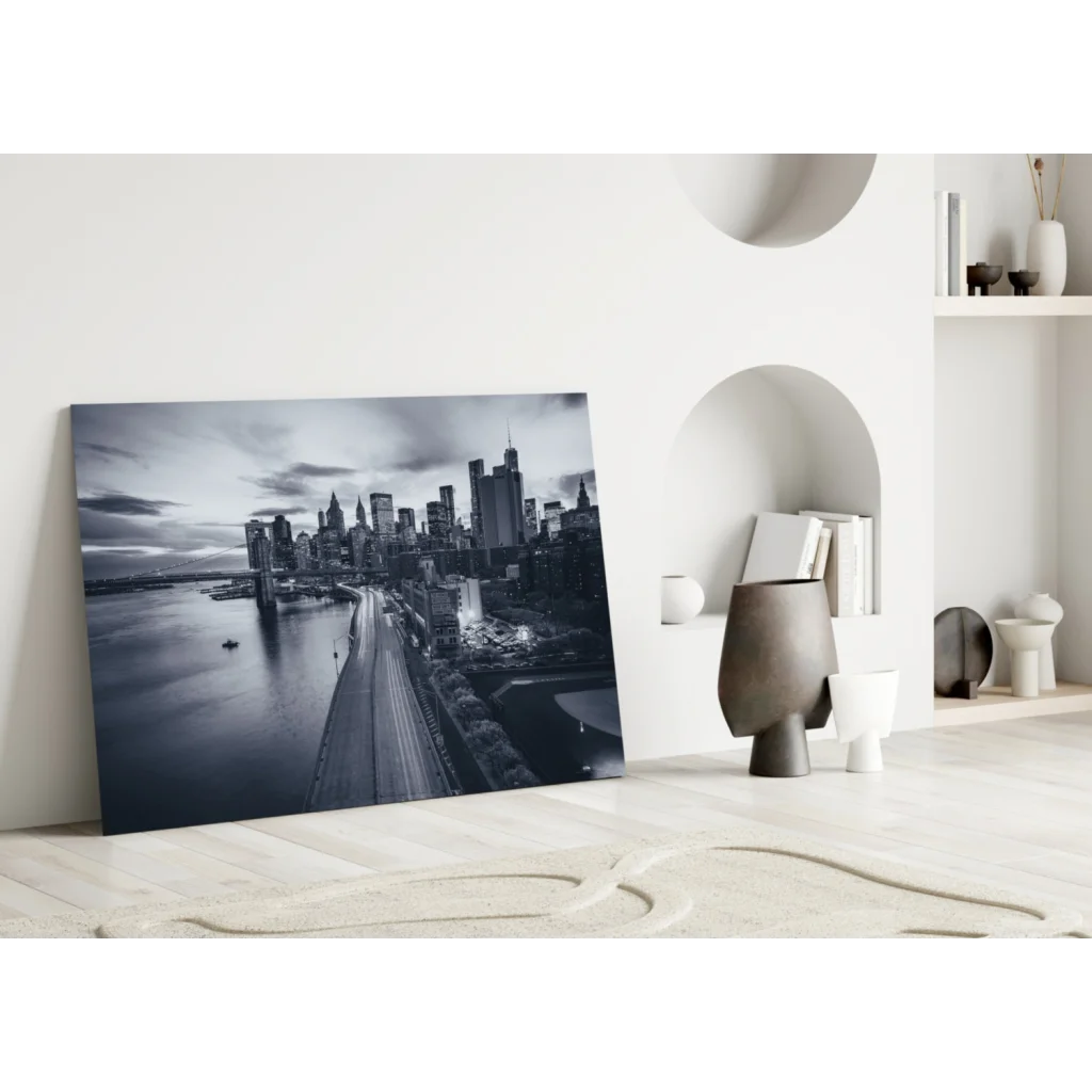 Black-and-white cityscape glass wall art leaning on white wall