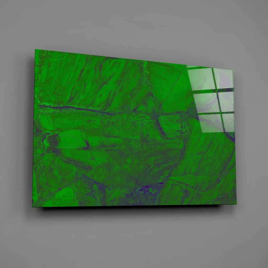 Vibrant green abstract glass wall art with purple swirls on gray wall