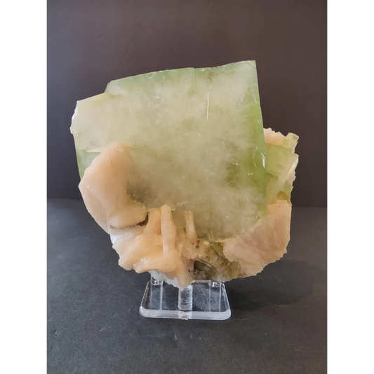 Green apophyllite cube with peach stilbite specimen on acrylic stand