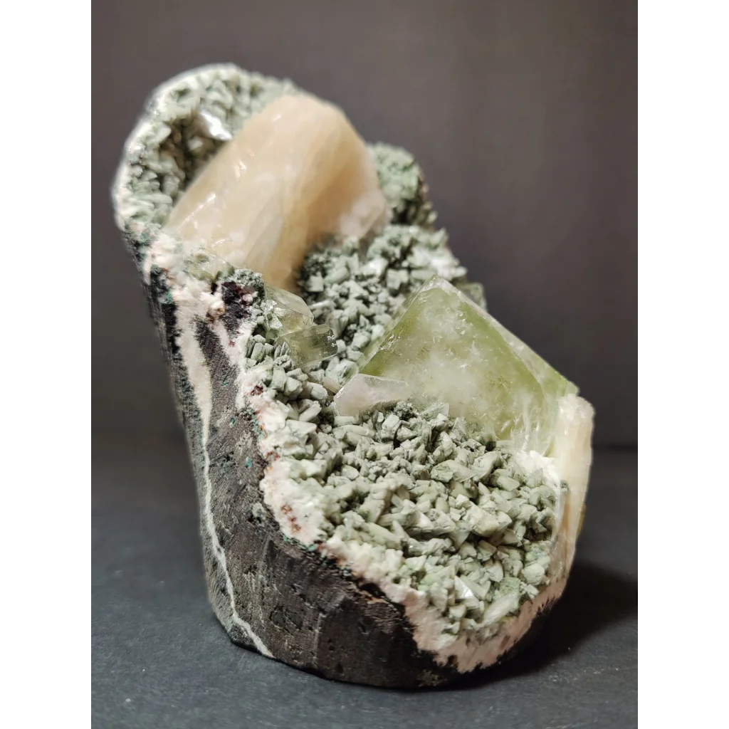 Green apophyllite cubes with peach stilbite on heulandite specimen