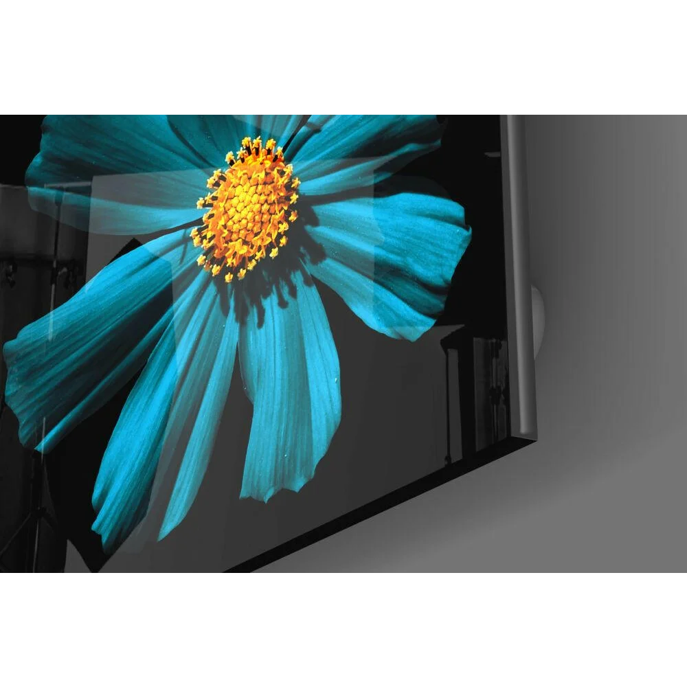 Vibrant turquoise cosmos glass wall art with golden center on monitor