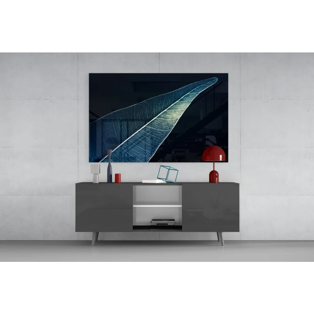 Stunning glass wall art of illuminated leaf on black-blue canvas