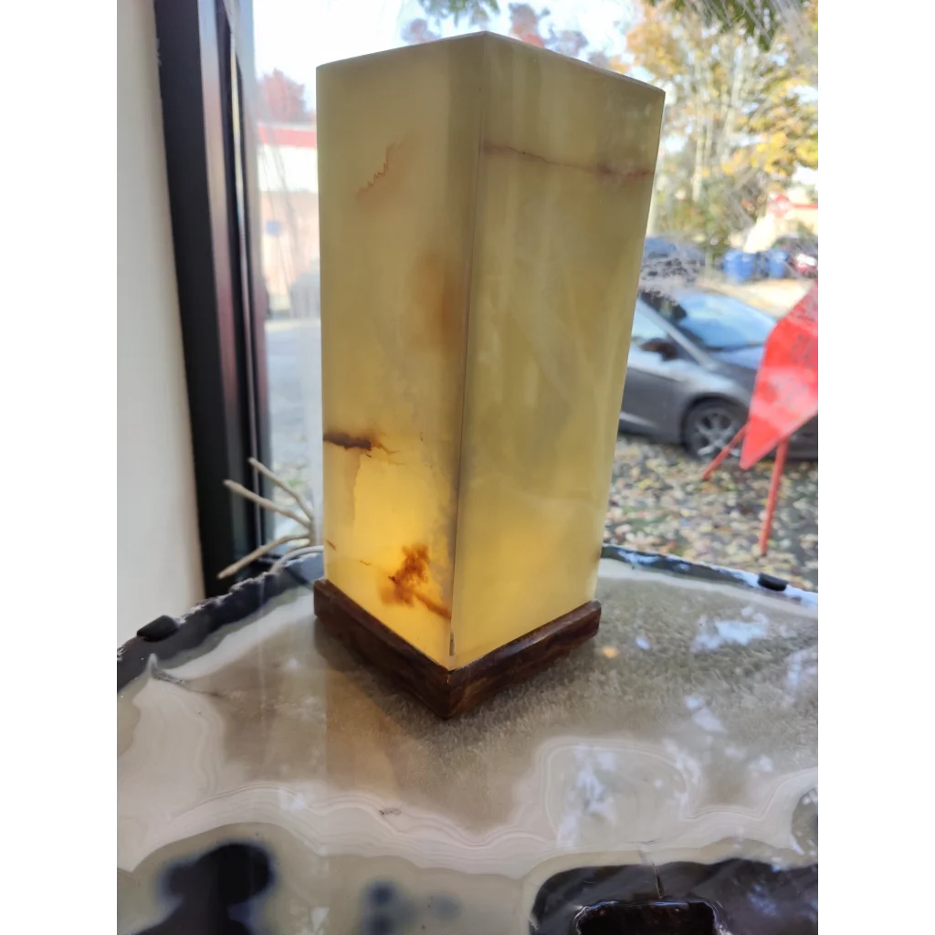 Green onyx square lamp with warm amber glow and wood base