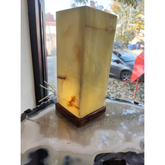 Green onyx square lamp with warm amber glow and wood base