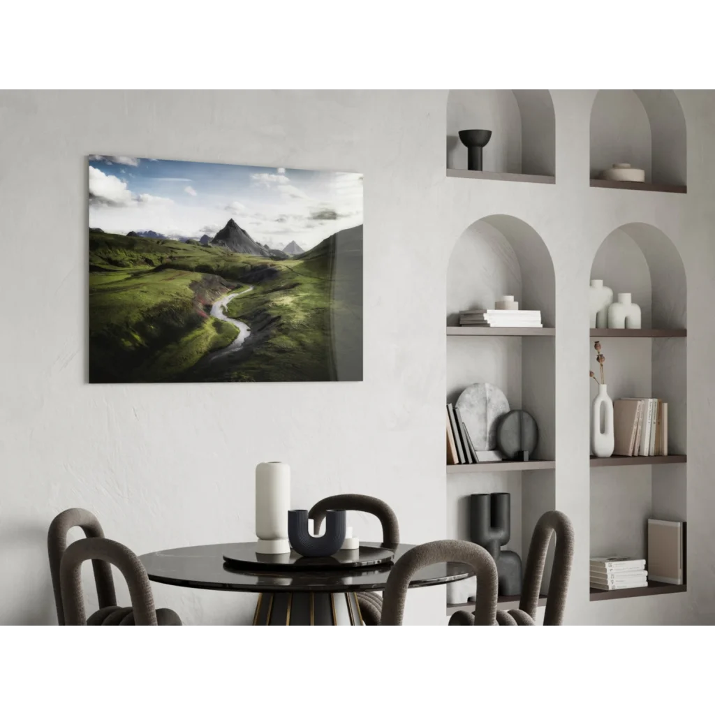 Vibrant green mountain glass wall art with winding river under cloudy sky