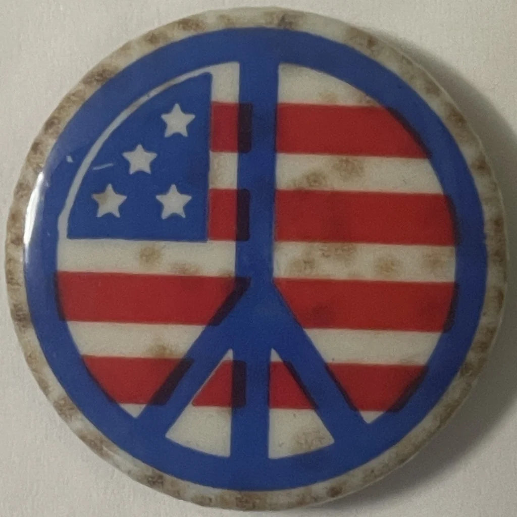 Peace symbol button featuring an American flag design for Groovy 60s Vietnam War Peace Pins