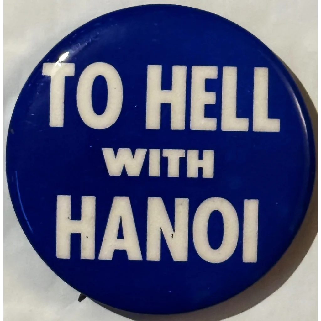 Blue button with white text saying TO HELL WITH HANOI on a funky 60s peace pin