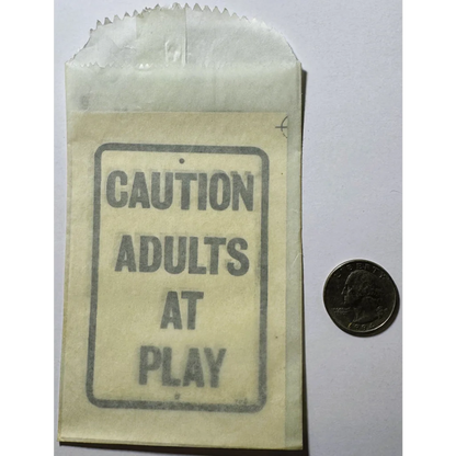 Paper bag with caution adults at play sign from vintage 1960s adults mid century NOS Americana collection