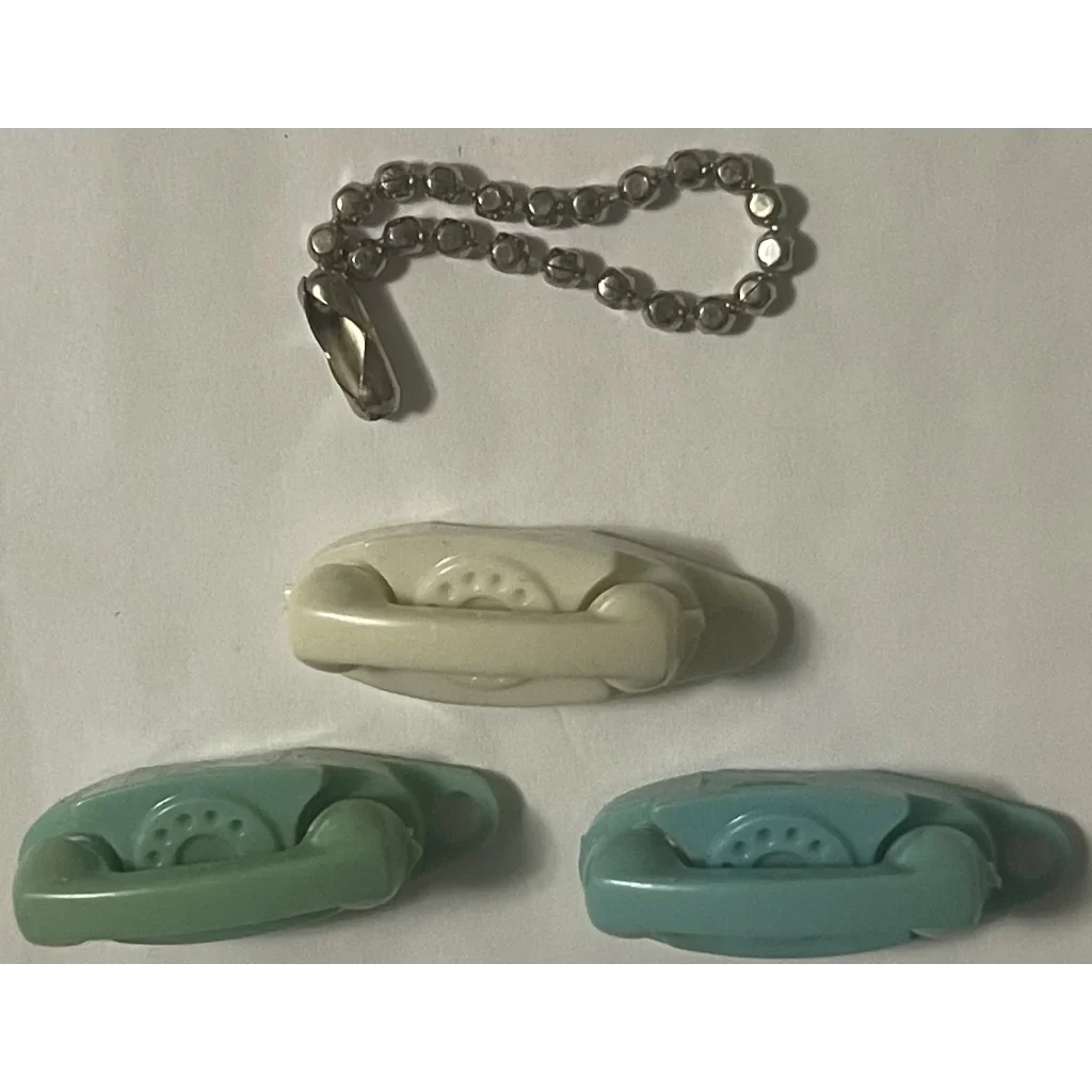 Bathtub-shaped pastel soap dishes with a metal chain for a 1960s Green Princess vibe