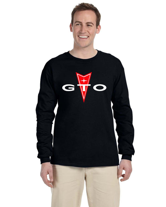 Front view of a smiling man in a black long-sleeve shirt with a red and white arrowhead logo and GTO text.